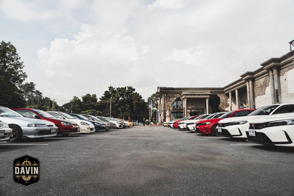 Rows of Honda Civic cars parked in the massive parking lot of the Davin Cafe event venue during a large car enthusiast gathering.