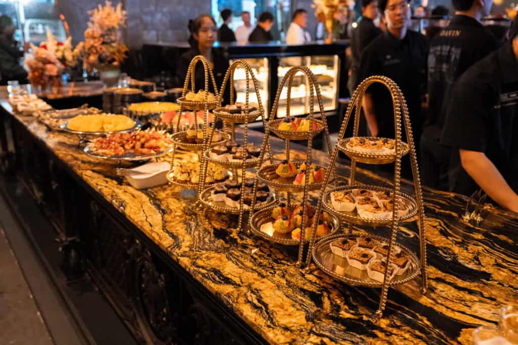 refined dessert display arranged on tiered stands at a restaurant catering venue, highlighting premium presentation for corporate events and formal celebrations