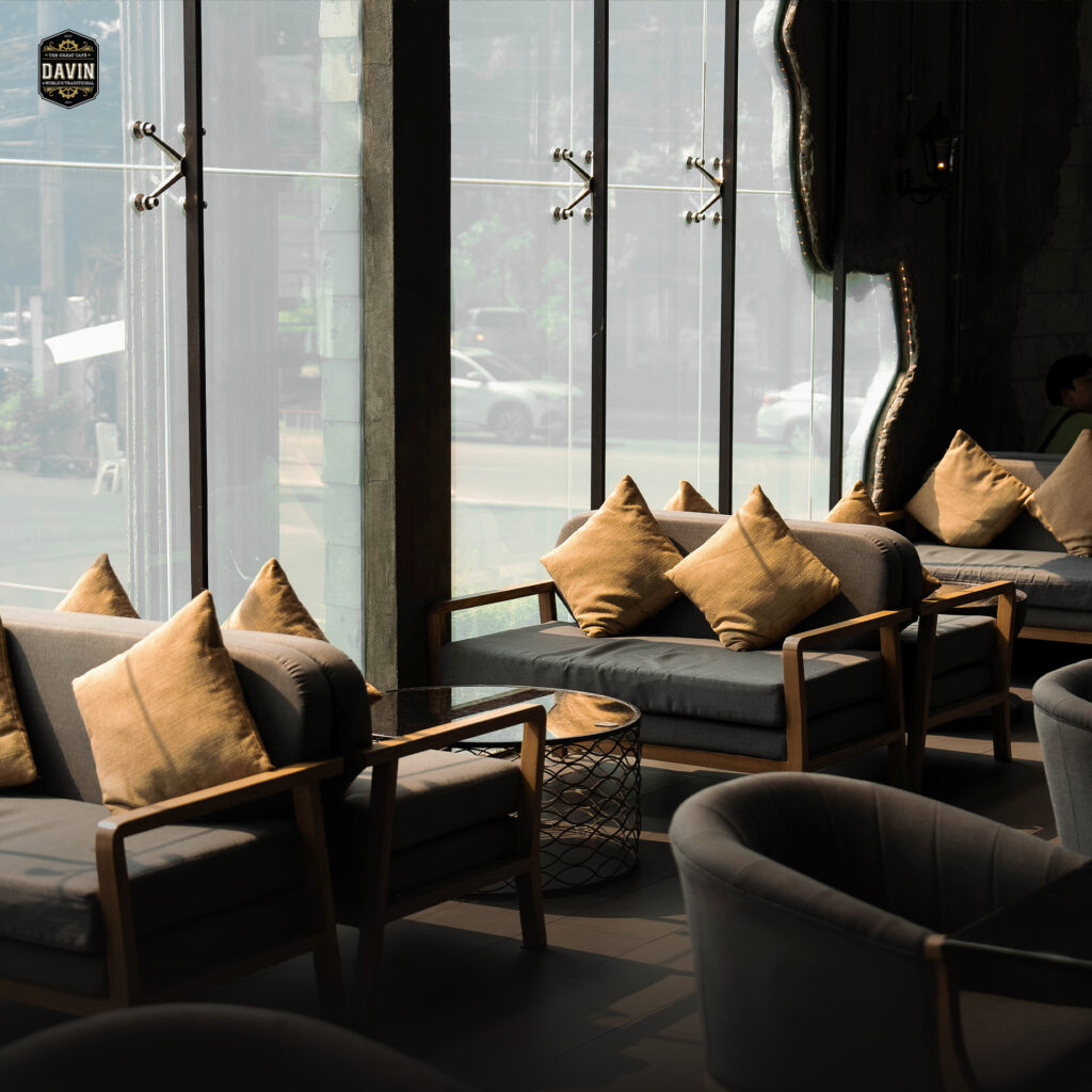 Comfortable lounge seating by the window at Davin Cafe, a Bangkok cafe with natural light, refined interiors, and relaxed seating areas designed for coffee breaks, casual meetings, and premium private dining or event gatherings.