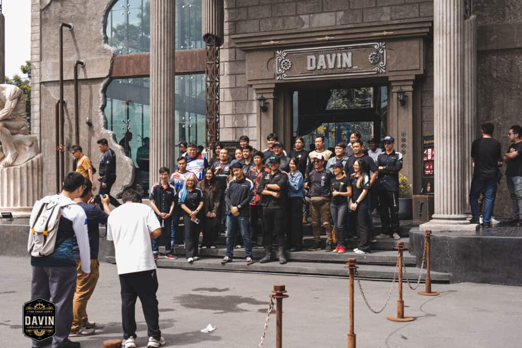 BMW Motorrad community group photo at the entrance of Davin Cafe, showcasing a Bangkok fan meet venue with a strong check-in point, spacious event support, and a memorable setting for brand gatherings, fan activities, and community experiences.