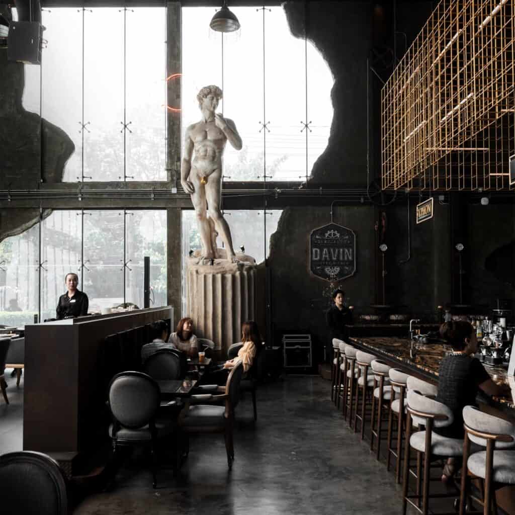 Interior of DAVIN CAFE, a Bangkok restaurant featuring luxury industrial design and iconic art-inspired decor