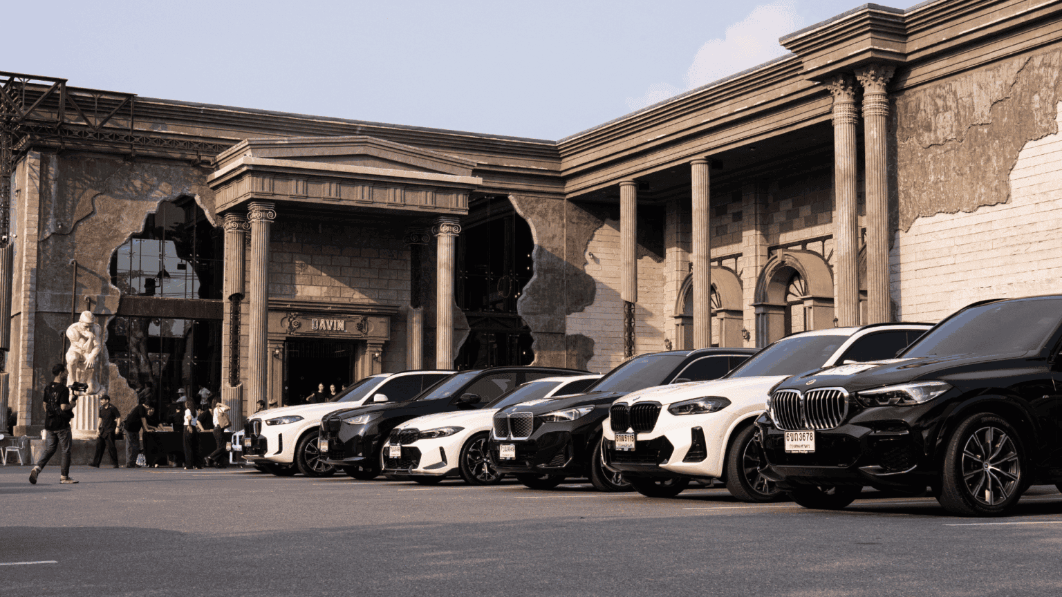 Outdoor event venue at DAVIN CAFE Bangkok hosting a luxury car event with spacious parking