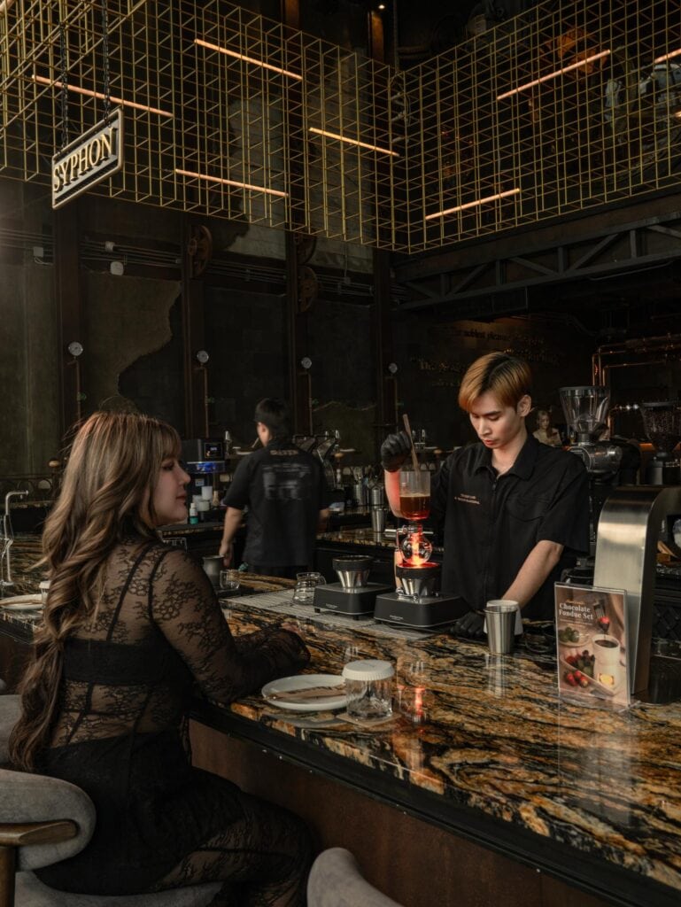 Places to Visit in Ramintra: DAVIN CAFE barista preparing specialty coffee in a European-inspired cafe